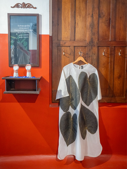 A White ecoprint T-Shirt hangs on a wooden wall - Beautiful Homes